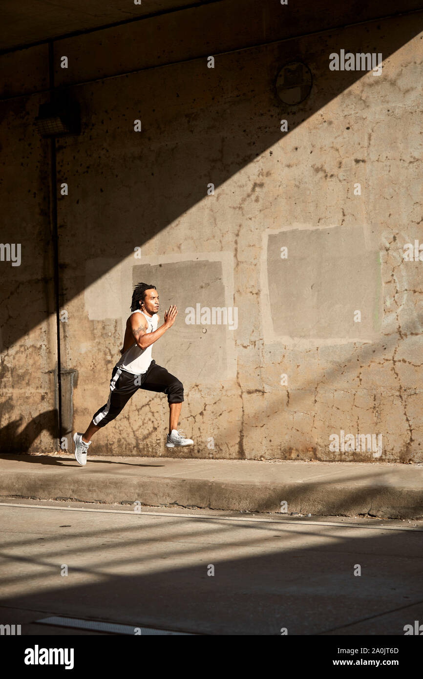 African American Man Running On Sidewalk Stock Photo Alamy