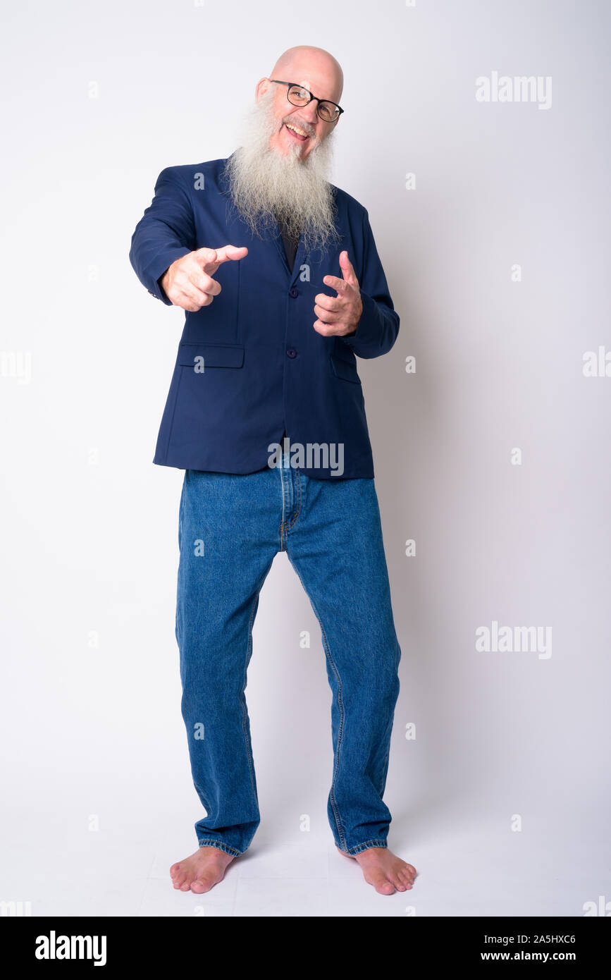 Full Body Shot Of Happy Mature Bearded Bald Businessman Pointing At