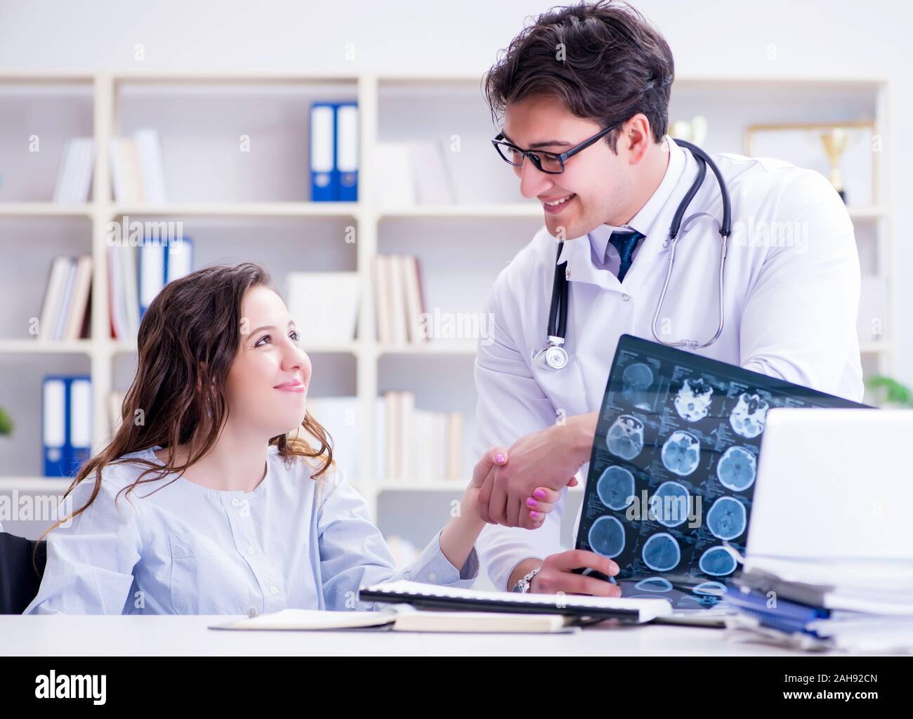 The Doctor Explaining To Patient Results Of X Ray Imaging Stock Photo