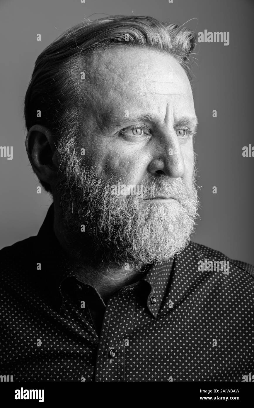 Face Of Mature Bearded Man Thinking In Gray Background Stock Photo Alamy