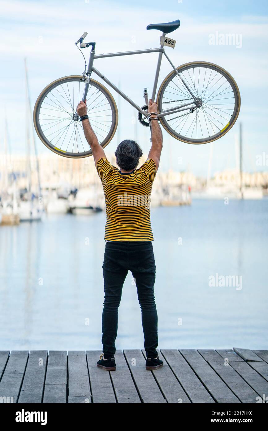 Back View Mature Man Standing Boardwalk Fixie Bike Hi Res Stock