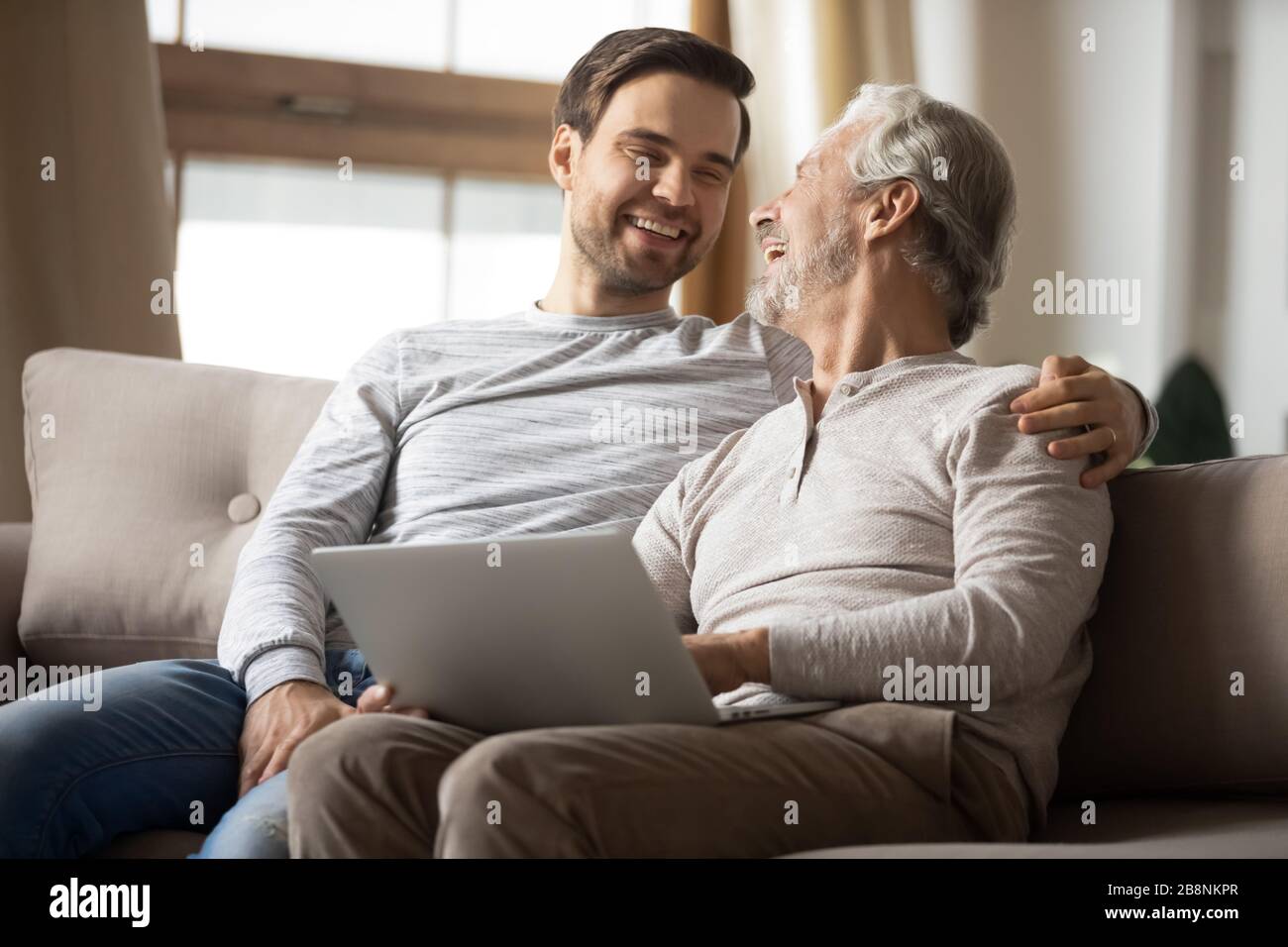 Mature Father And Adult Son Browsing Laptop Together Stock Photo Alamy