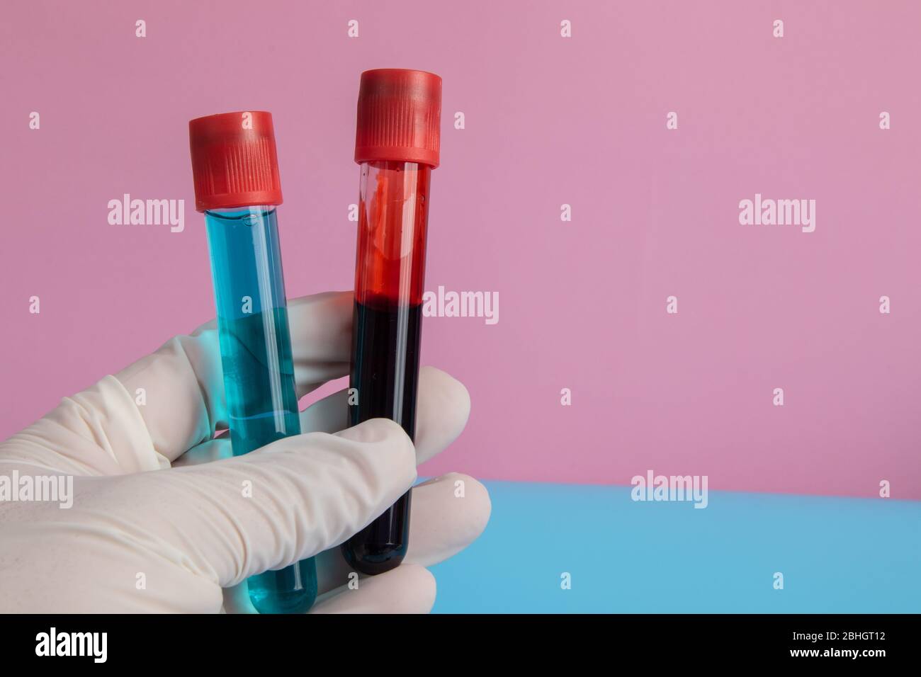 Hand With Glove Holding Blood Tubes And Blue Drug With Copy Space Stock