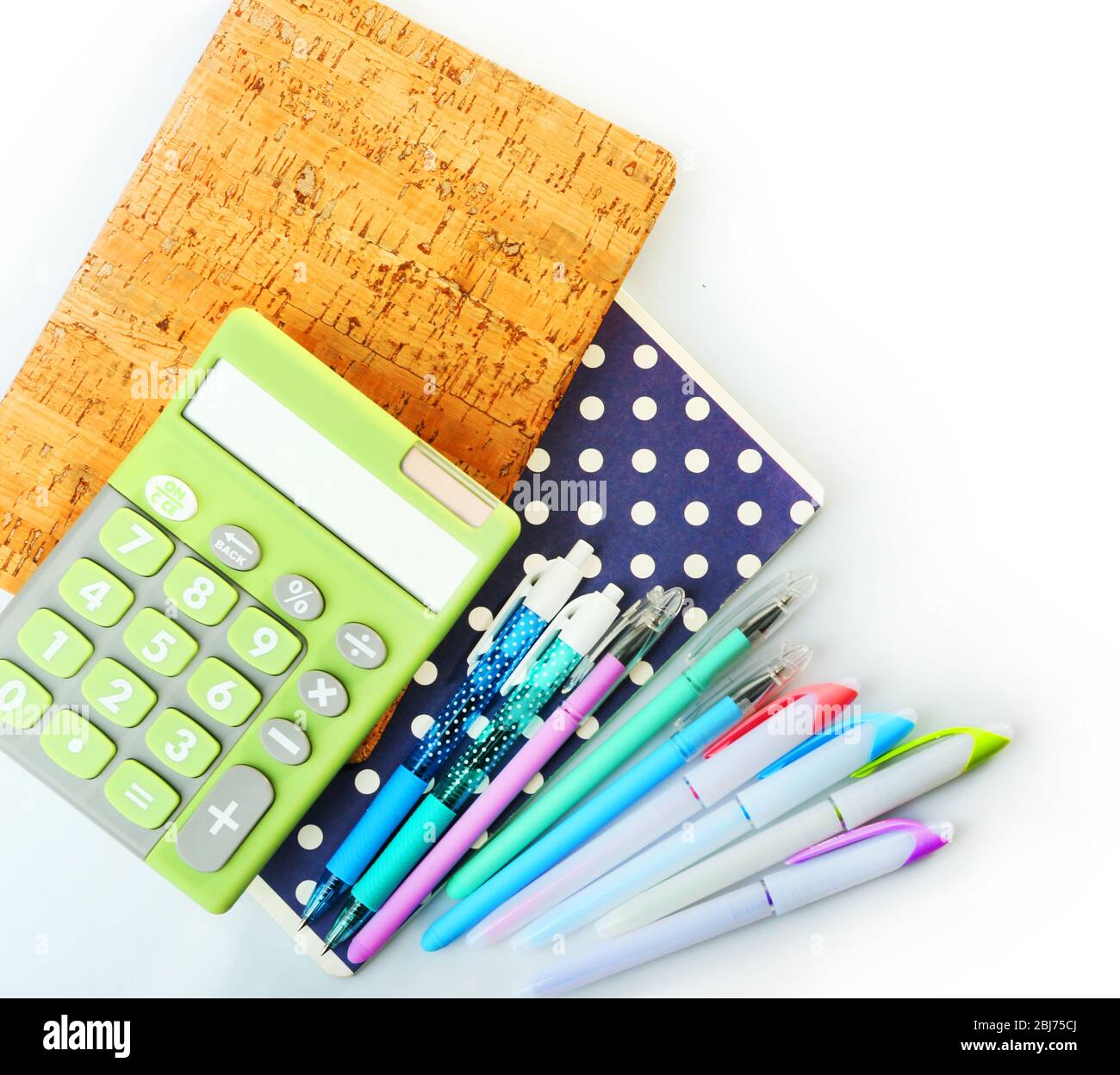 A Pile Of Stylish Notebooks And Stationary Isolated On White