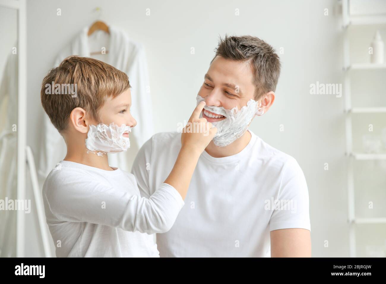 Father And Son Shaving Together In Bathroom Stock Photo Alamy