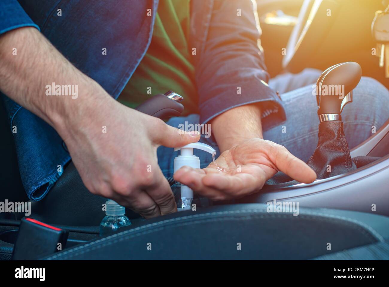 Man Sitting In The Car Disinfect His Hands To Avoid Coronavirus