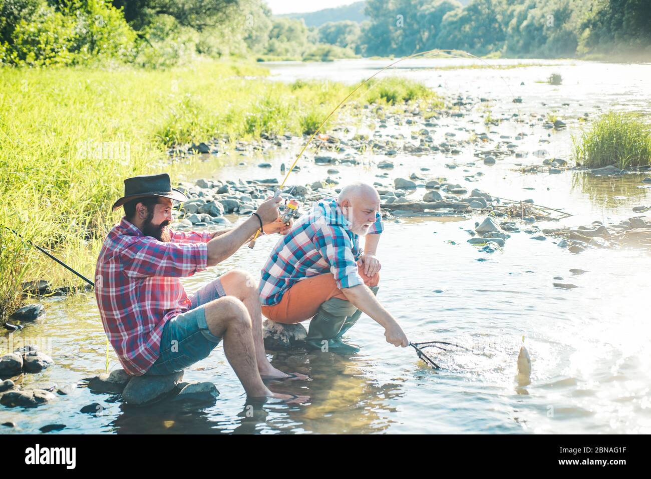 Mature Father And Son Sitting Fishing Hi Res Stock Photography And