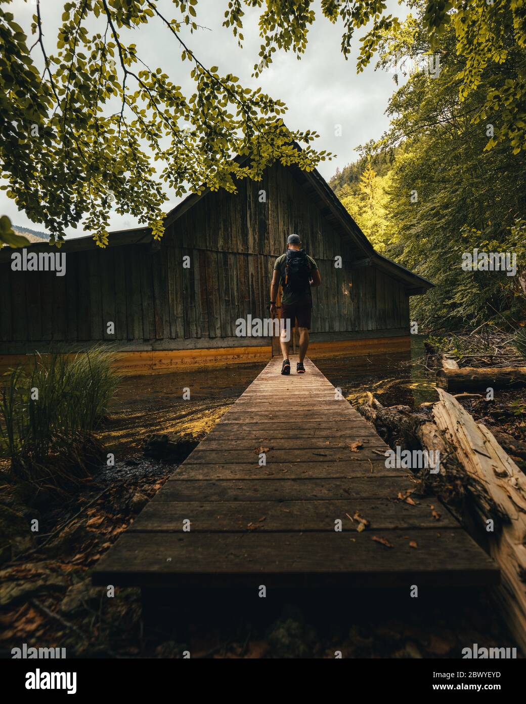 Old Wooden Fishing Hut At Lake Toplitzsee In Austria With A Person From