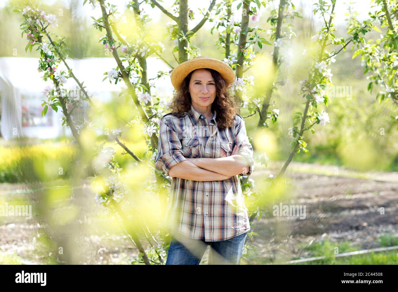 Portrait Of Confident Mature Female Farmer Standing With Arms Crossed