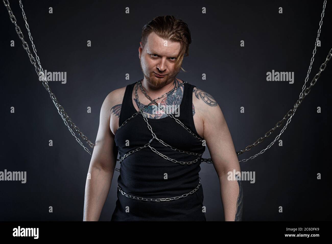 Photo Of A Tattooed Bearded Man Bound In Chains Stock Photo Alamy