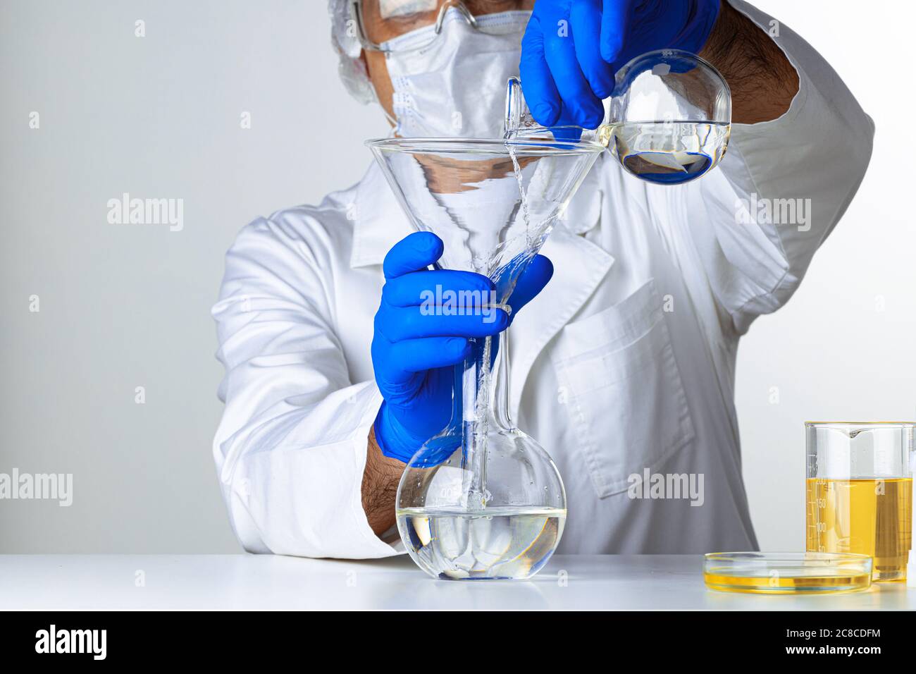 Scientist Hands Holding Some Liquid In A Glassware In Laboratory For