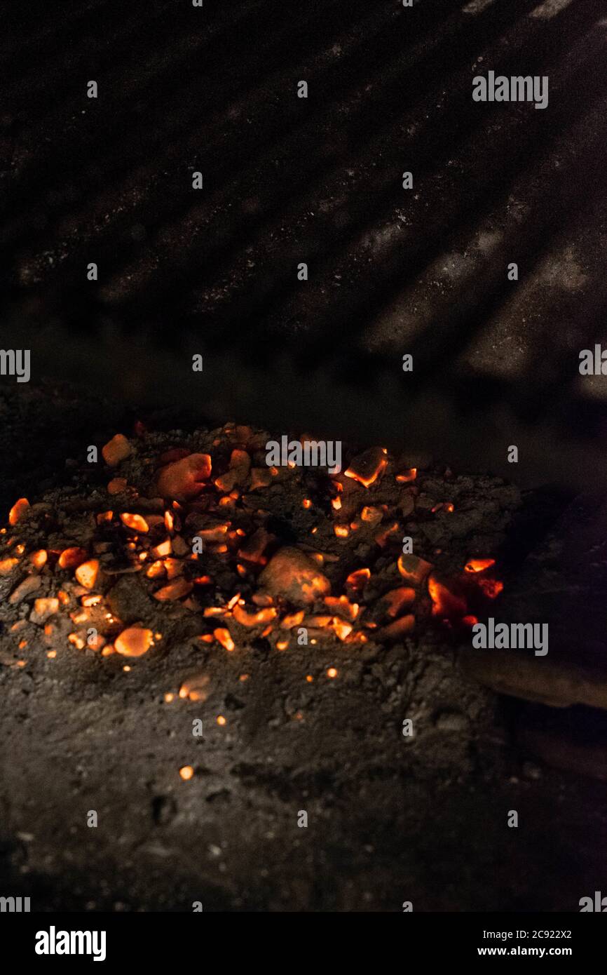 Vertical Shot Of A Pile Of Red Burning Coal In A Barbeque Grill Stock