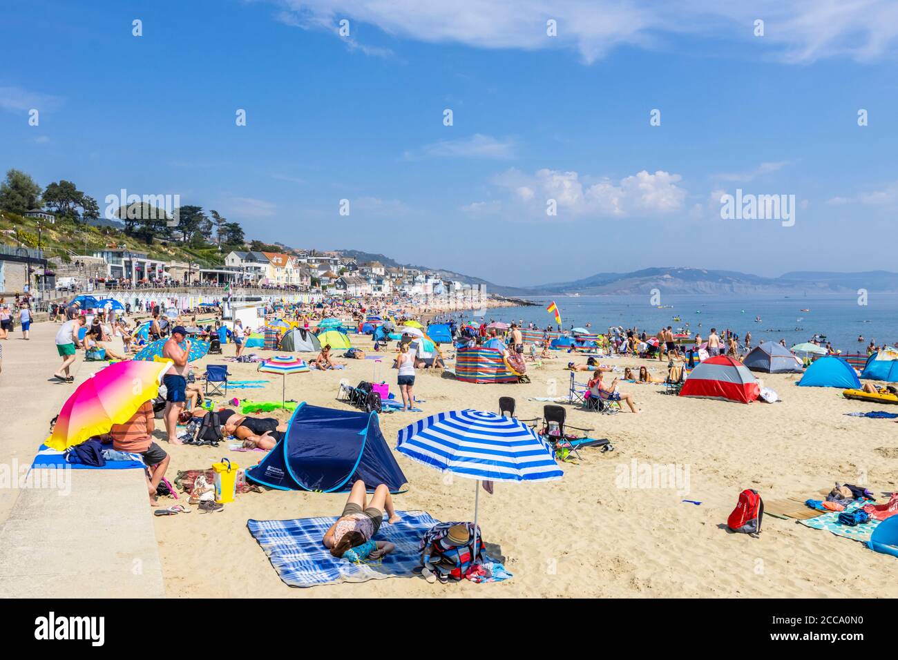 The Crowded Beach And Seafront In High Season At Lyme Regis A Popular