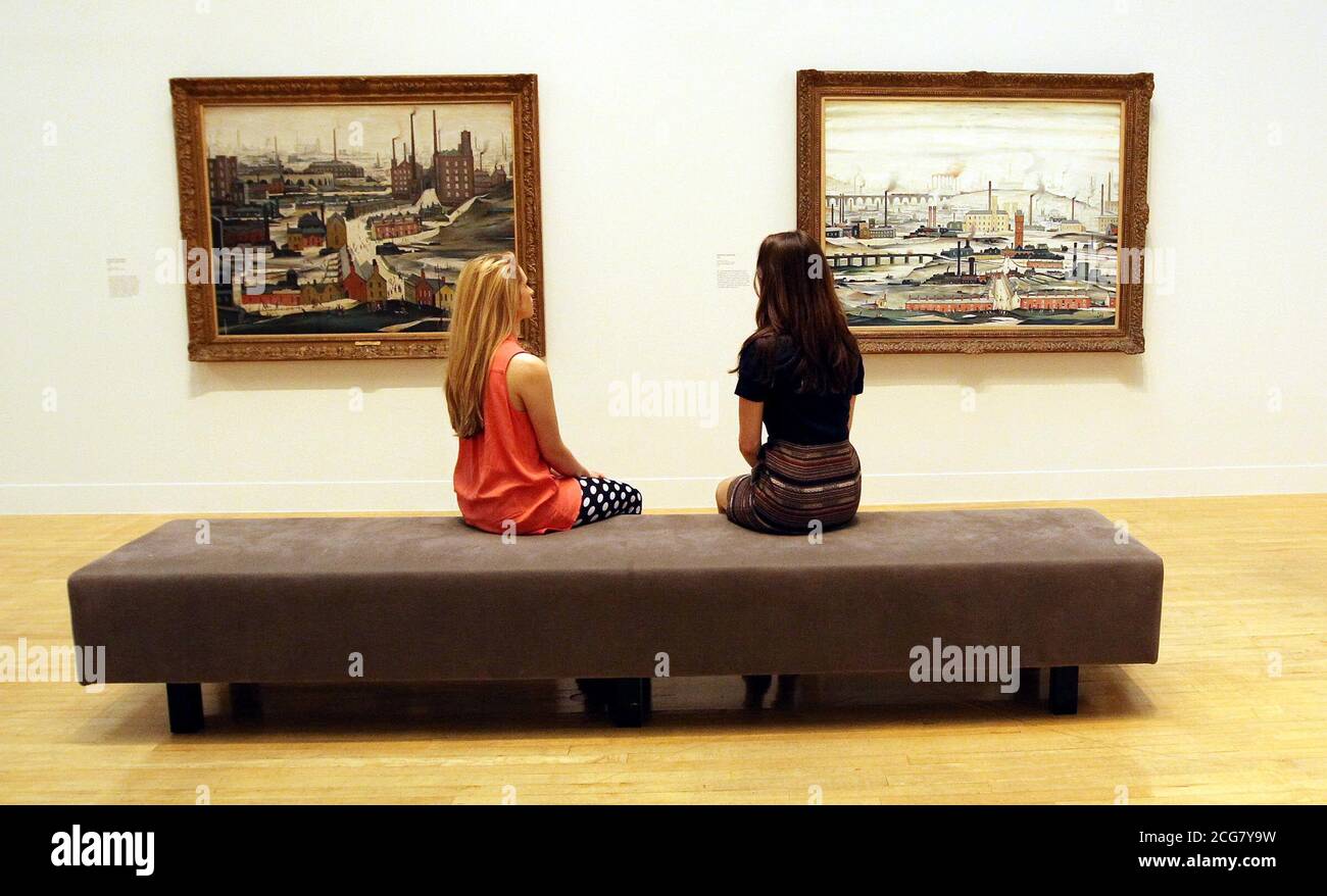 Staff Members At The Tate Britain Look At Lowry Paintings Which Have