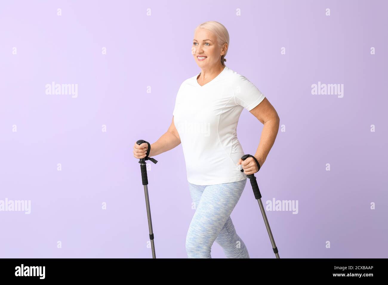 Mature Woman With Walking Poles On Color Background Stock Photo Alamy