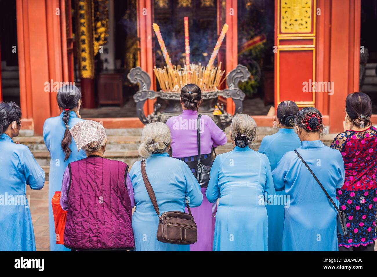 Group Of Elderly Asian Women Praying In A Buddhist Temple Stock Photo