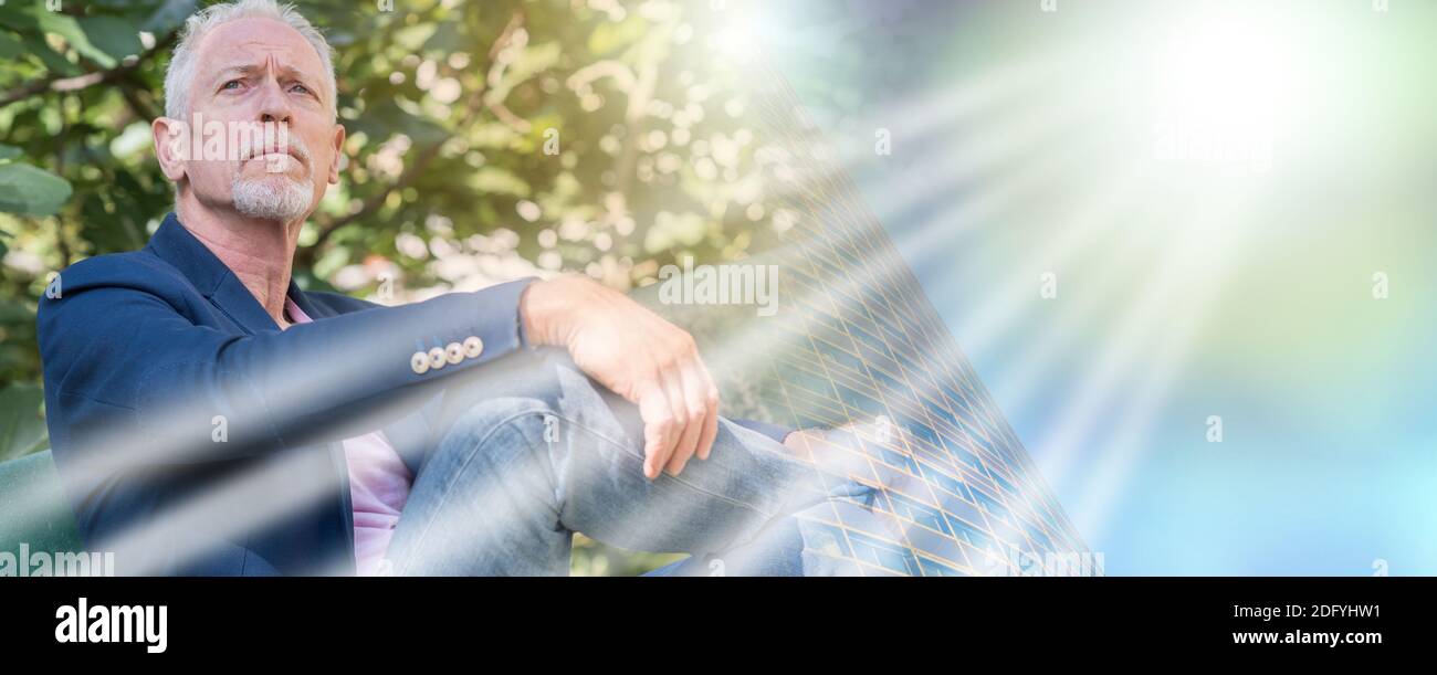 Portrait Of Handsome Mature Man Sitting On A Bench Outdoors Light