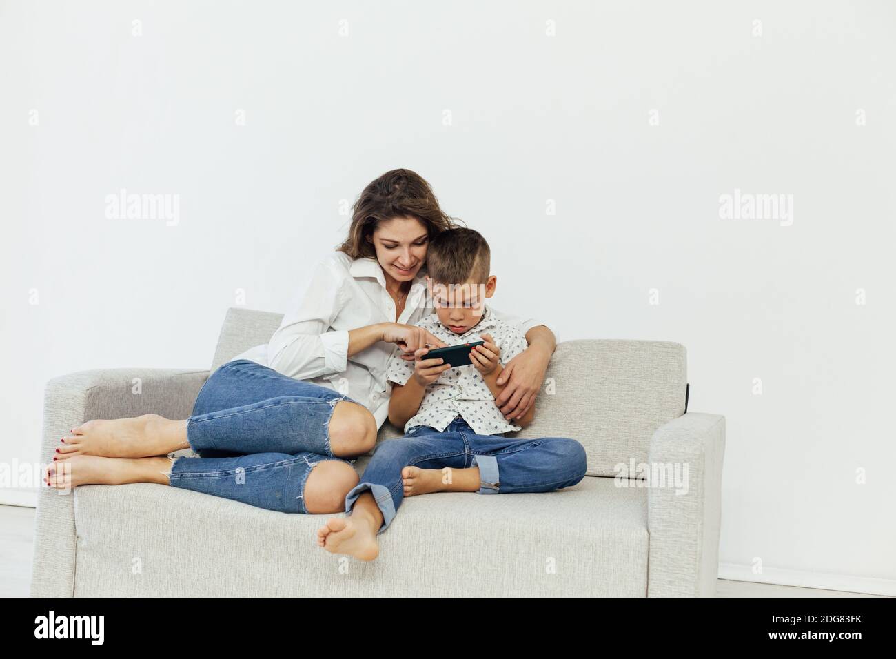 Mom And Son Watch Smartphone Games Online Stock Photo Alamy