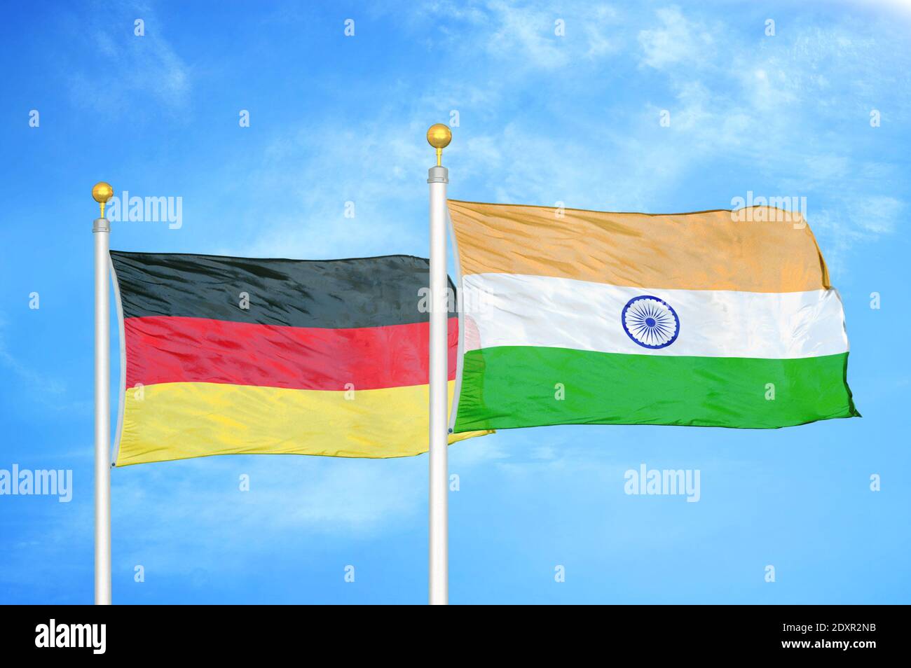 Germany And India Two Flags On Flagpoles And Blue Cloudy Sky Stock