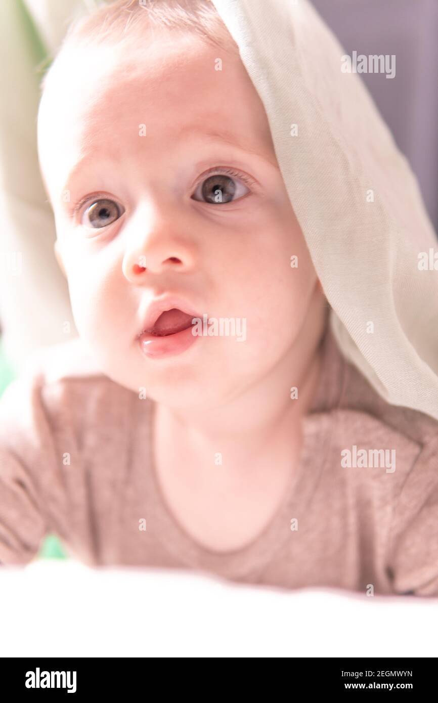 Six Month Old Baby With A White Blanket Over Her Head Stock Photo Alamy