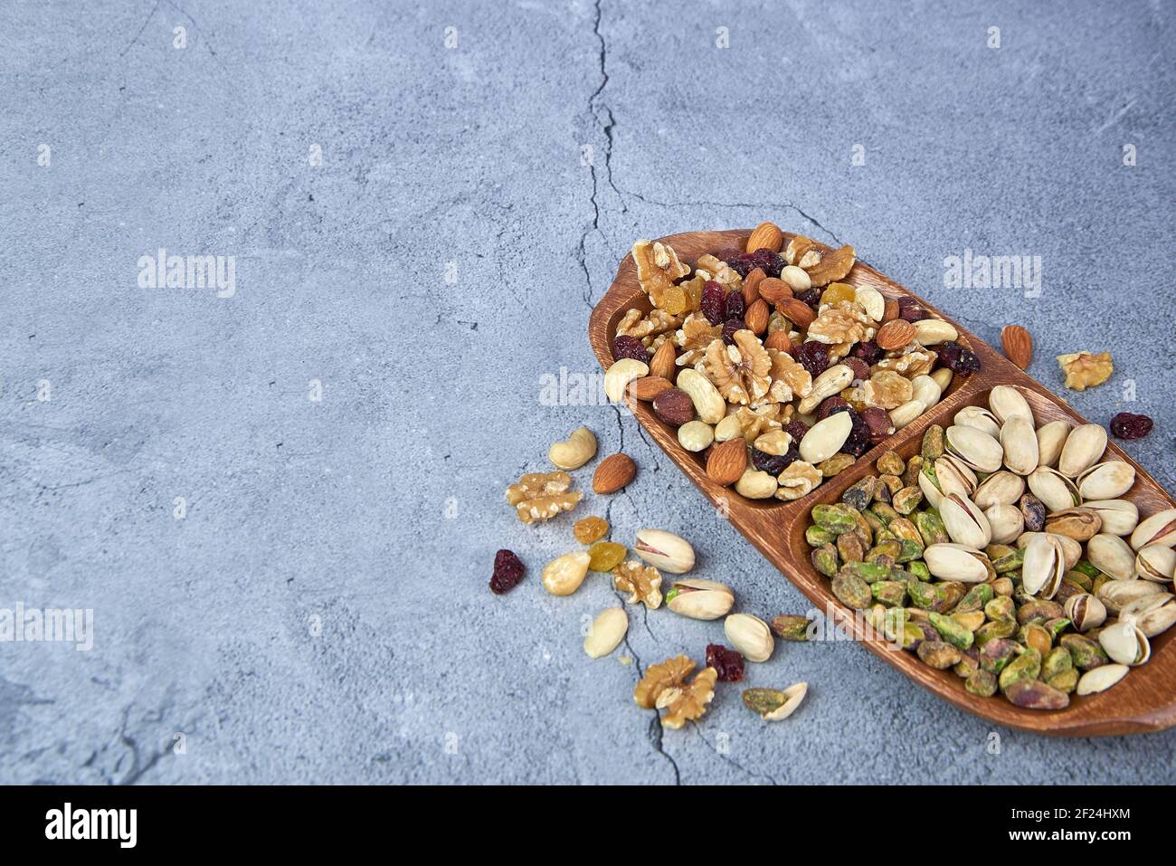 Mix Dried Fruits With Nuts Pistachios Cashew Nuts In Wooden Bowl On