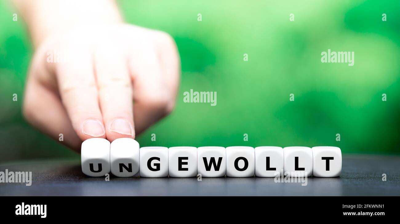 Hand Turns Dice And Changes The German Word Ungewollt