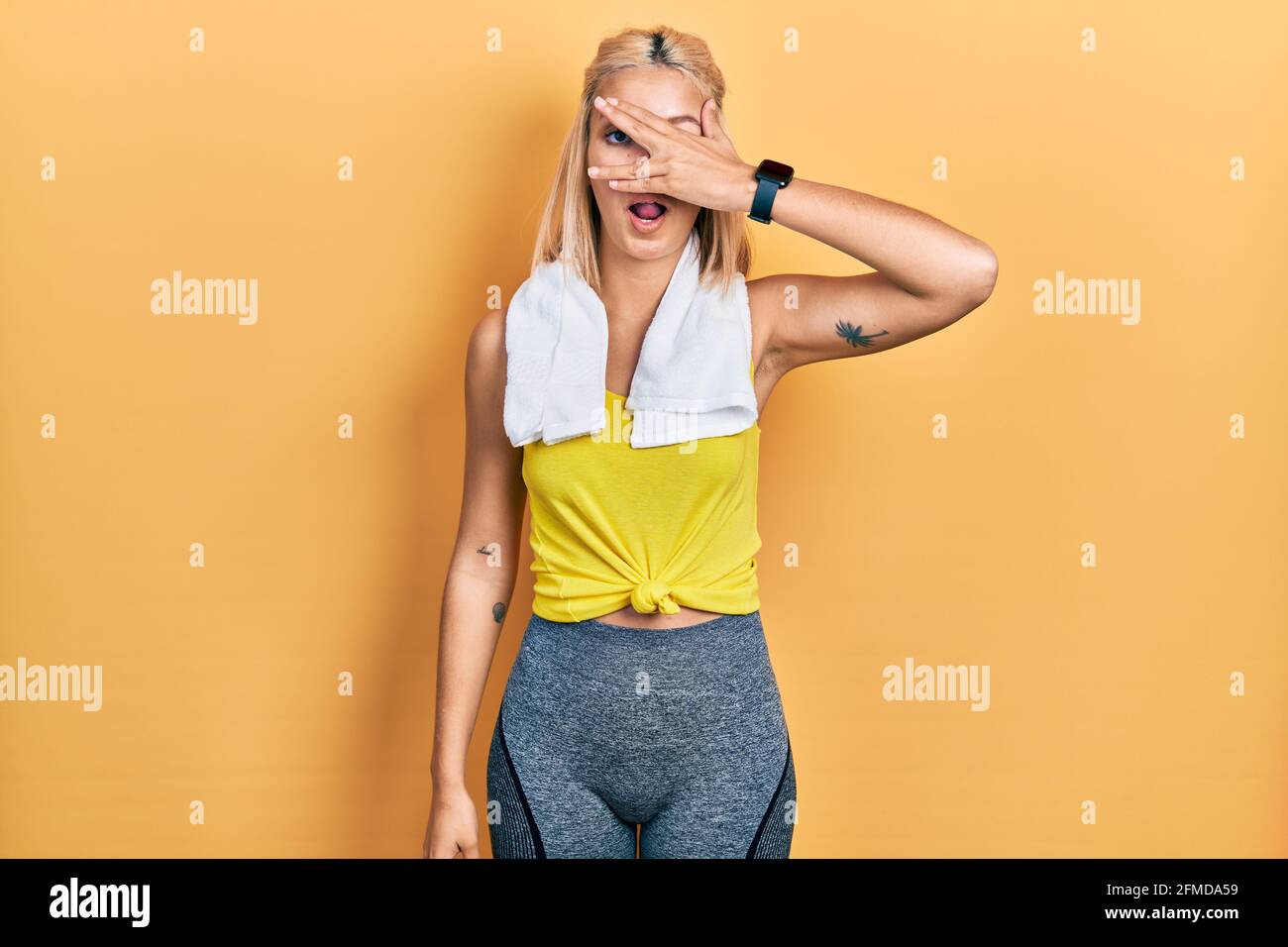 Beautiful Blonde Sports Woman Wearing Workout Outfit Peeking In Shock