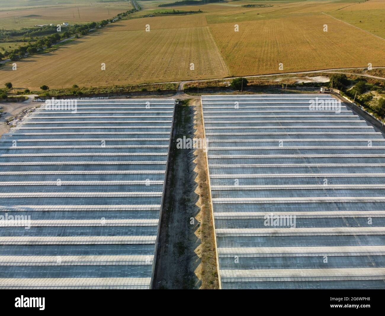 Aerial Drone View Of Huge Areas Glass Greenhouse For Growing Vegetables