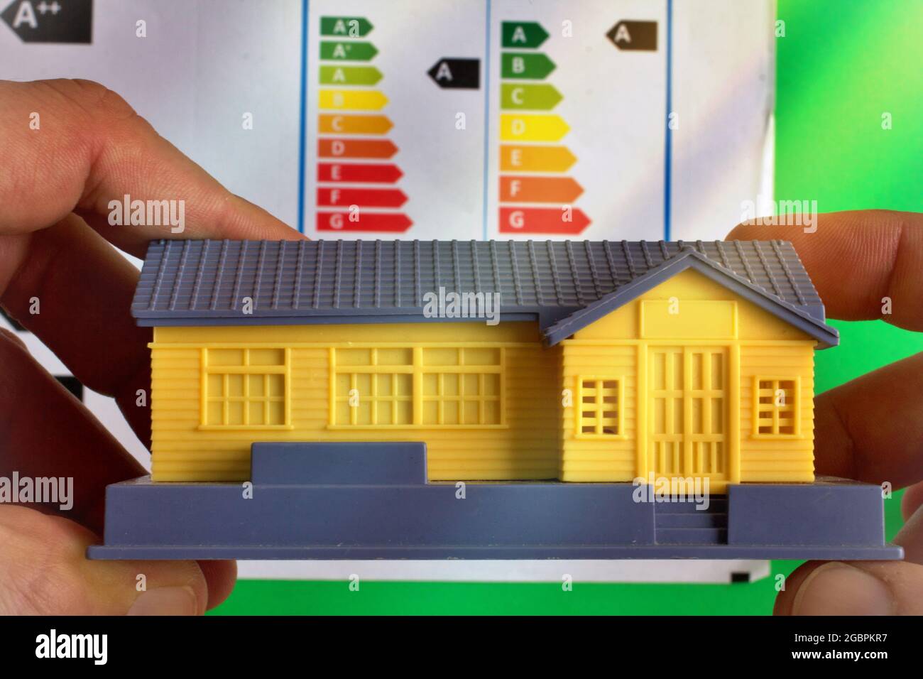 Hands Holding A House With A Classification Graph As Background Energy