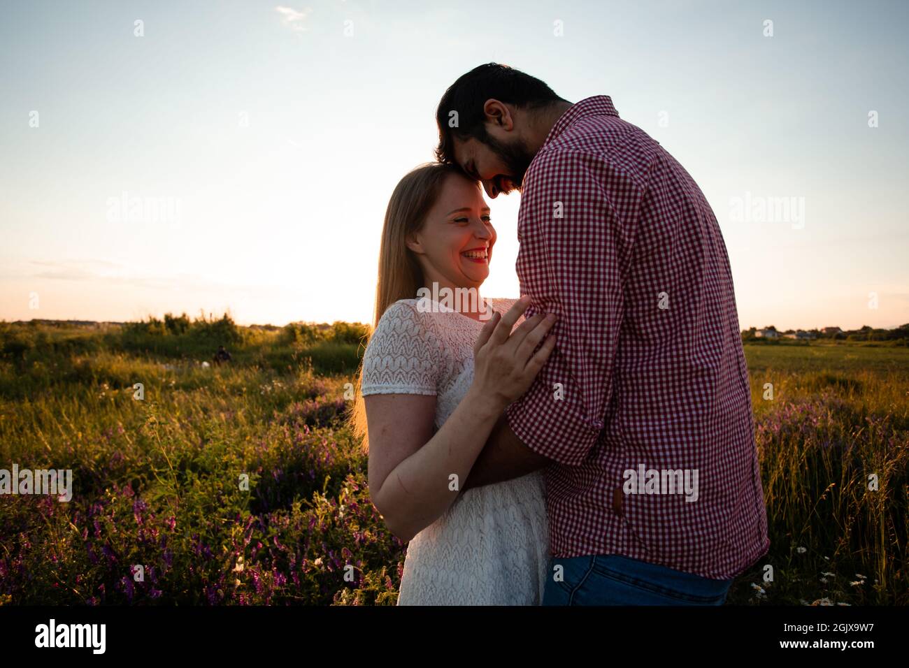 Embracing Couple In Rays Of Setting Sun Stock Photo Alamy