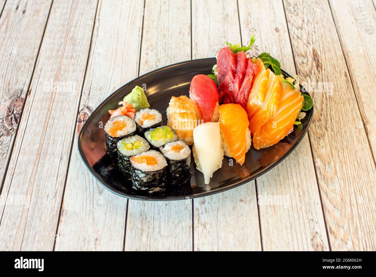 Assorted Sushi Platter With Maki Stuffed With Rice And Avocado Red