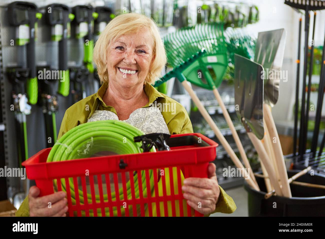 Happy Female Customer With Shopping Basket In Hardware Store Buys