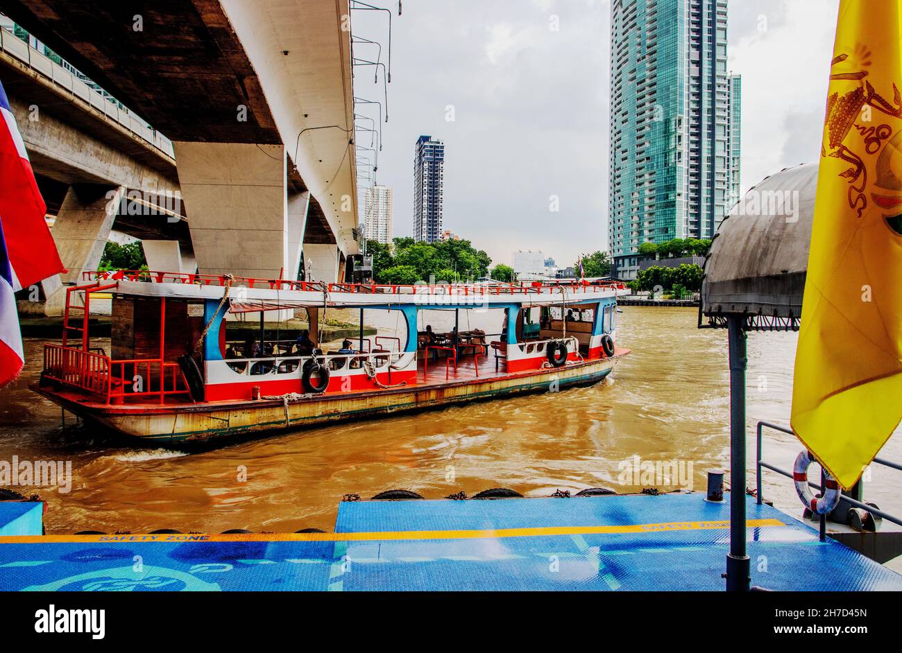 A Ferry Boat Cross The Chao Phraya River At The Sathorn Pier In Bangkok