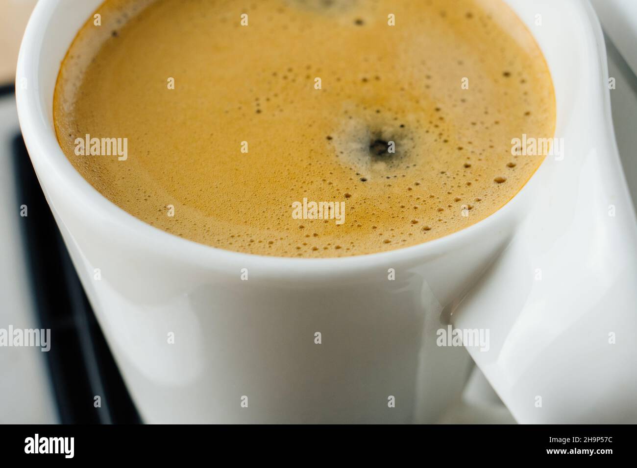 Close Up Photo Of Fresh Espresso With Foam In White Cup Top View From