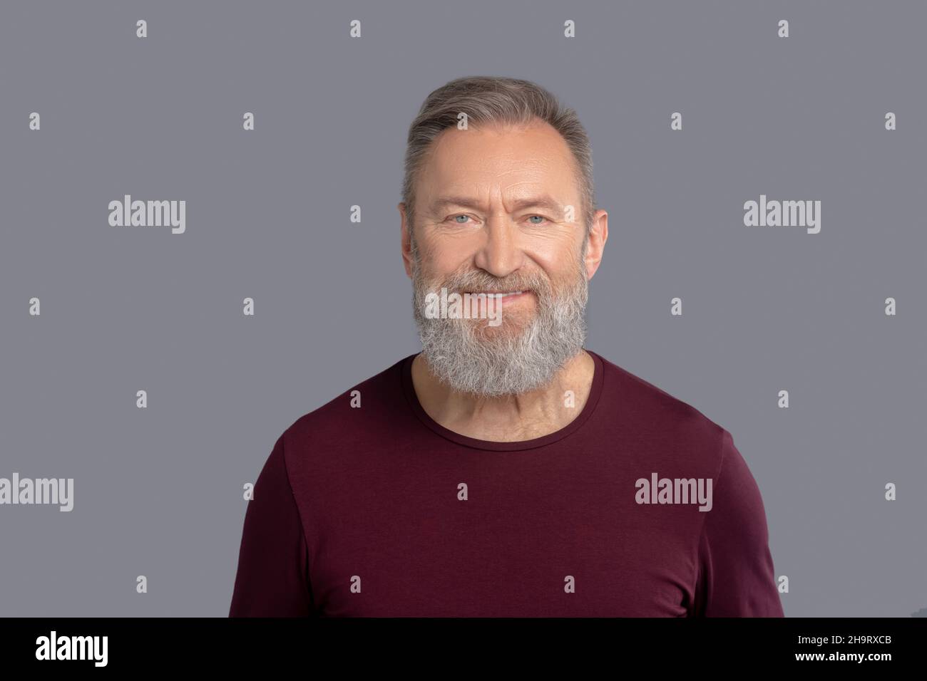 Mature Man In Burgundy Shirt Looking Positive Stock Photo Alamy