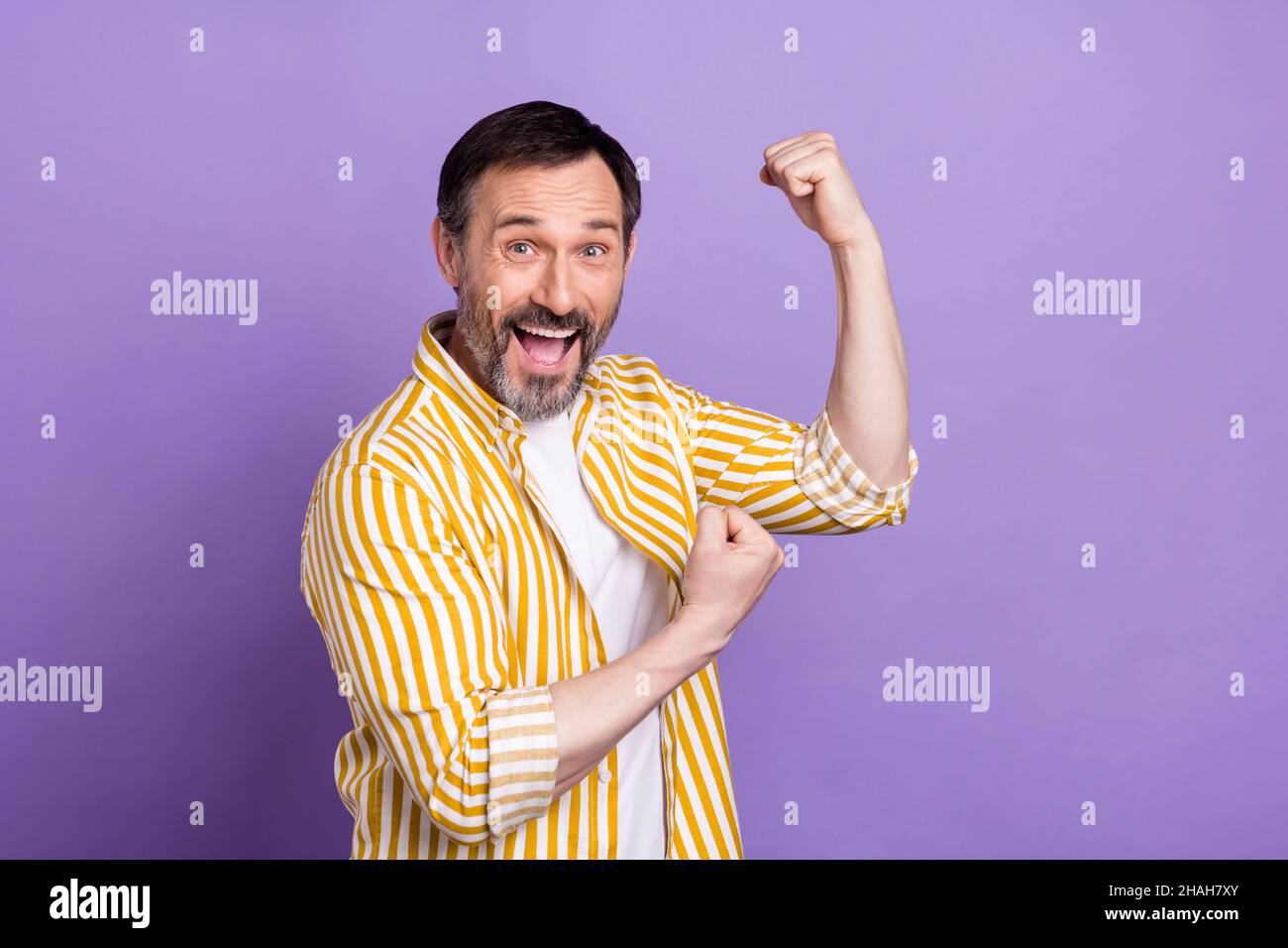 Photo Of Sweet Lucky Mature Man Dressed Striped Shirt Rising Fists