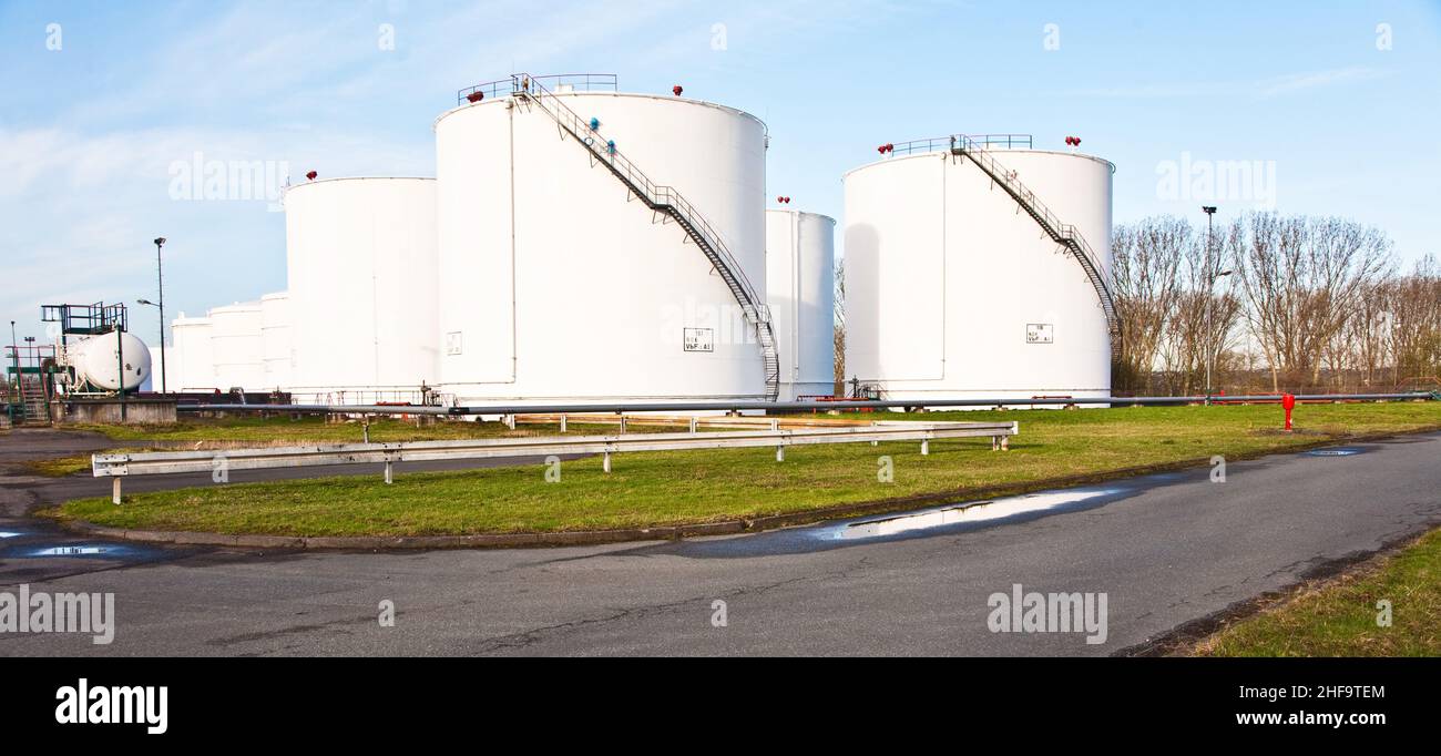 White Tanks For Petrol And Oil In Tank Farm With Blue Sky Stock Photo