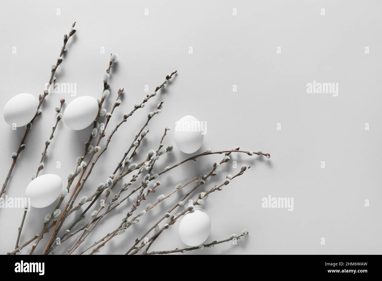 Easter Eggs And Pussy Willow Branches On Light Background Stock Photo