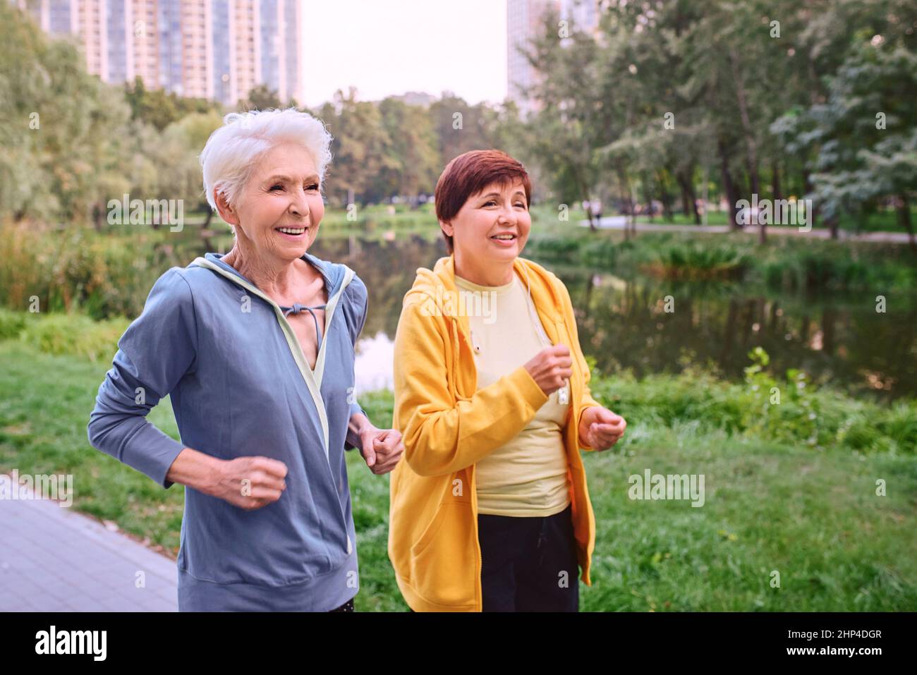 Two Mature Women Jogging In The Park Healthy Lifestyle Concept Stock