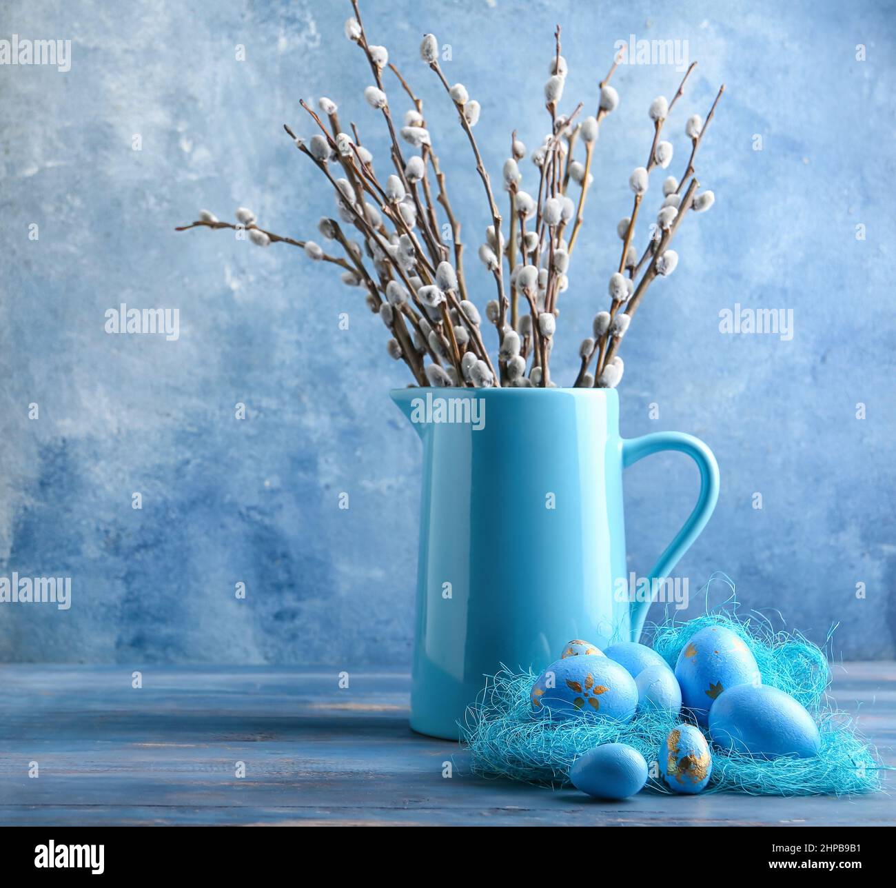 Composition With Painted Easter Eggs And Pussy Willow Branches On Blue