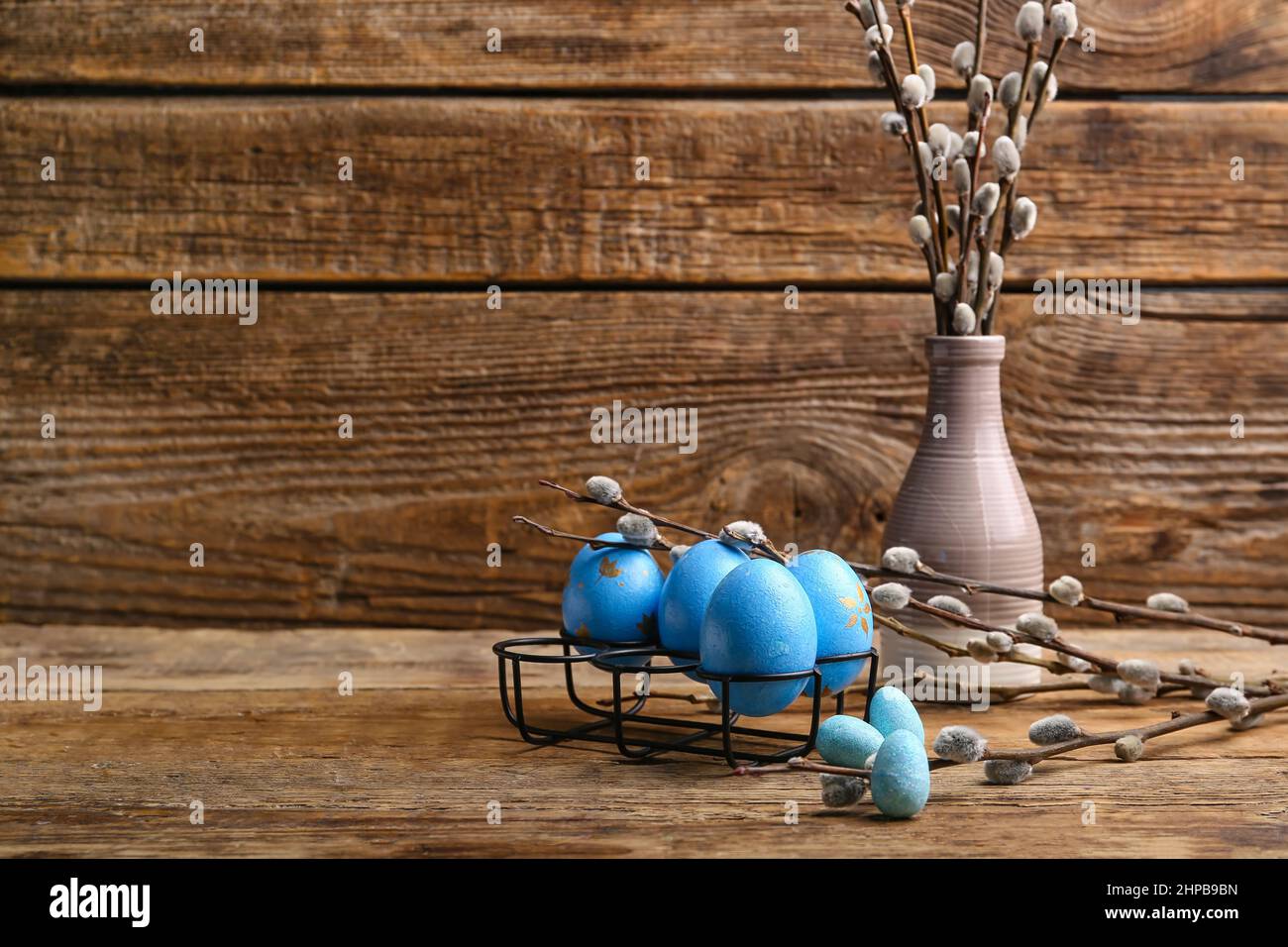 Painted Easter Eggs And Vase With Pussy Willow Branches On Wooden