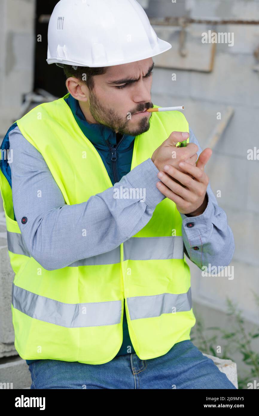 Builder Smoking Cigarette On Construction Site Stock Photo Alamy