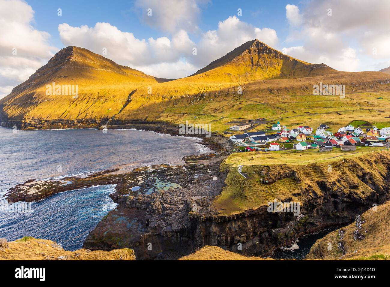 Small Village Gjogv Situated On The Slope Of The Mountain On Eysturoy