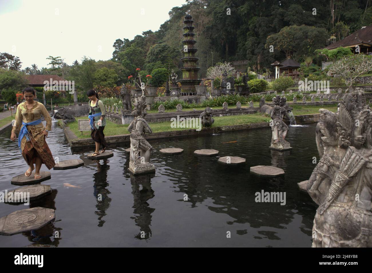 Women Visitors Walking On Stone Footsteps At Tirta Gangga Water Palace