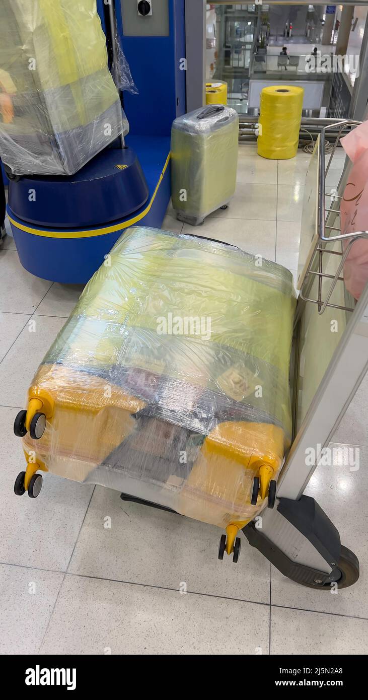 Cart Carry On Luggage At The Airport Suitcase Wrapping Up Protecting