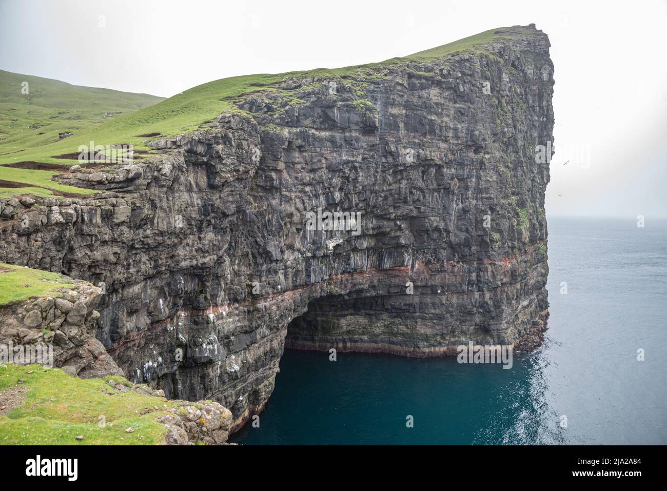 The Cliffs In Front Of Drangarnir Rock Formation Made By Two Sea Stacks