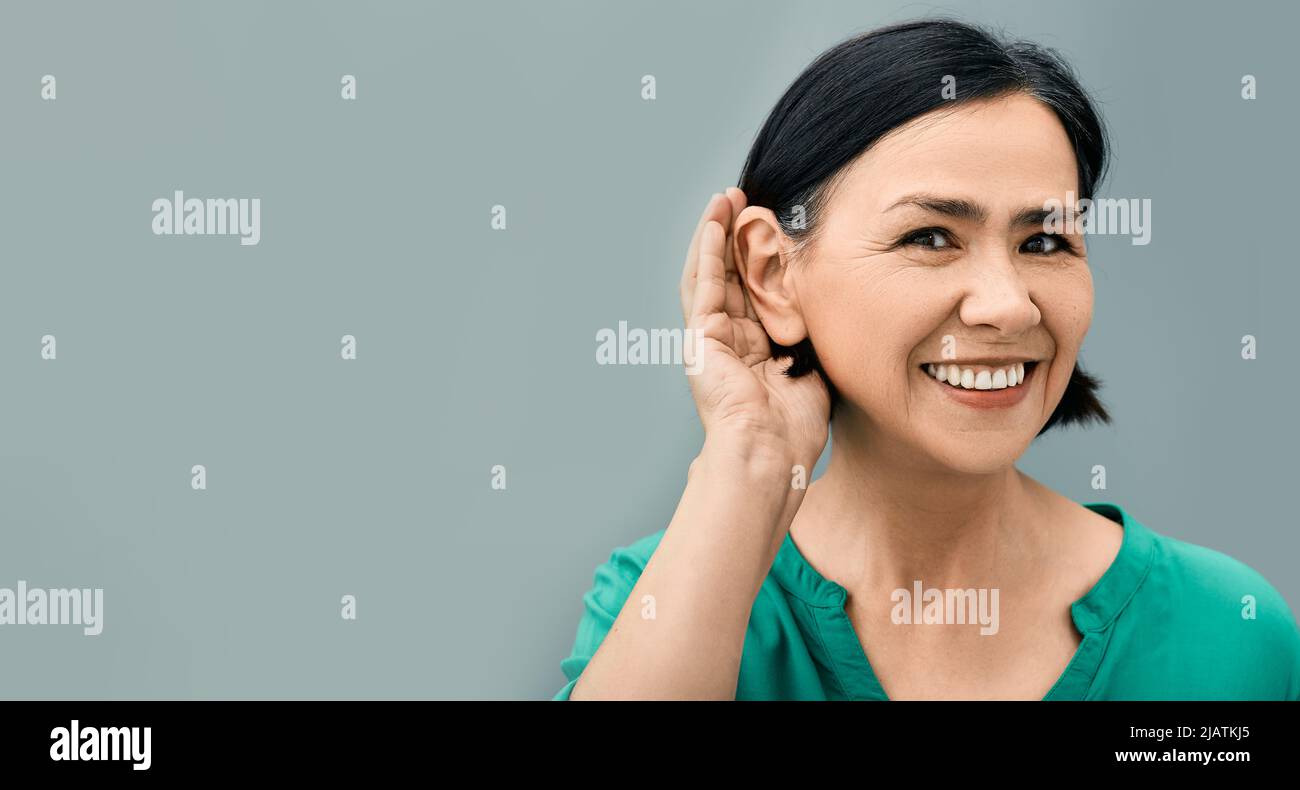 Mature Woman Listening Sound With Hand Near Ear For Hearing Check Up