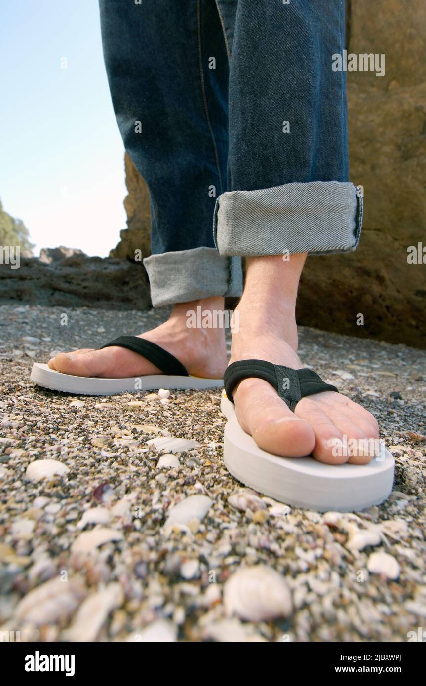 A Pair Of Feet In Thongs On Shelly Beach Stock Photo Alamy