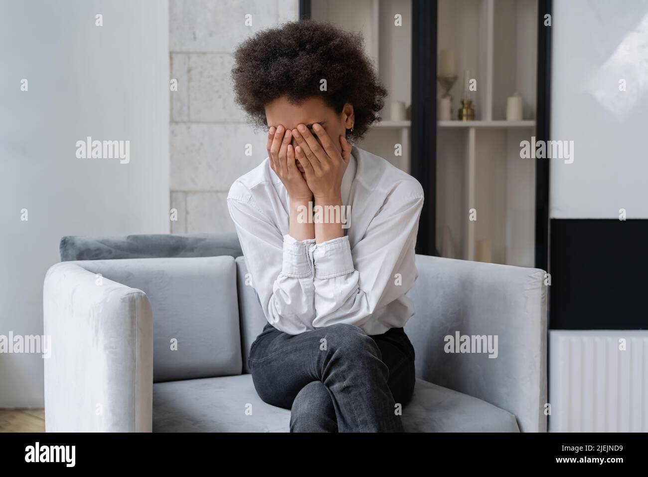 Stressed African American Woman In White Shirt Covering Face While