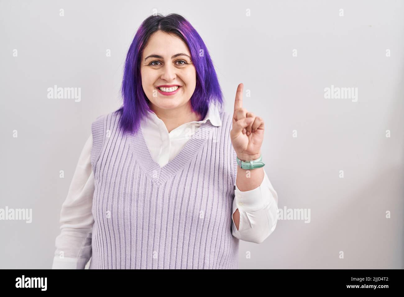 Plus Size Woman Wit Purple Hair Standing Over White Background Showing